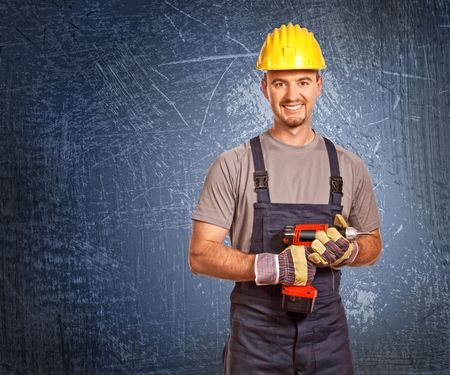 portrait of young manual worker and blue grunge background