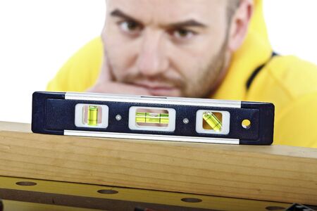 young manual worker check spirit level isolated on white