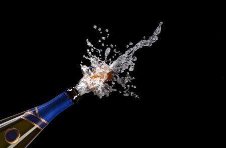 champagne bottle with shooting cork on black background
の写真素材