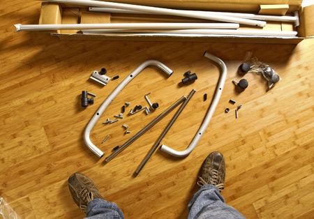 closeup image of furniture part on wood floor and man