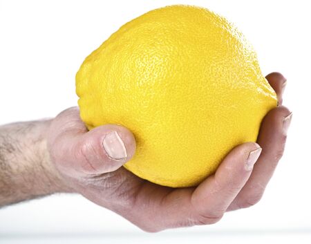 hand hold grapefruit on white backgroundの写真素材