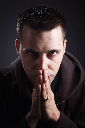 thinking man portrait caucasian model on dark backgroundの写真素材