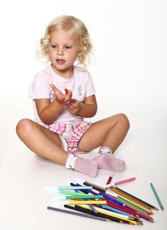 little girl play with colorful  pen on whiteの写真素材