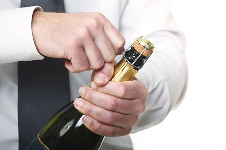 man open champagne bottle on white backgroundの写真素材