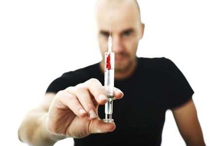 man with syringe isolated on white selective focus imageの写真素材