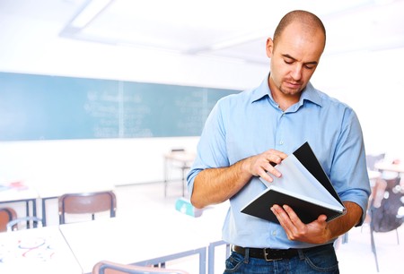 young caucasian teacher and classroom background