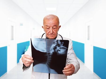 portrait of senior doctor checking xrayの写真素材