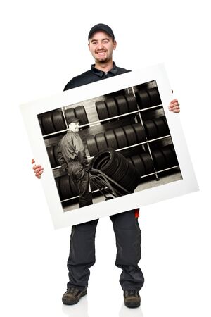 standing caucasian manual worker holding garage picture