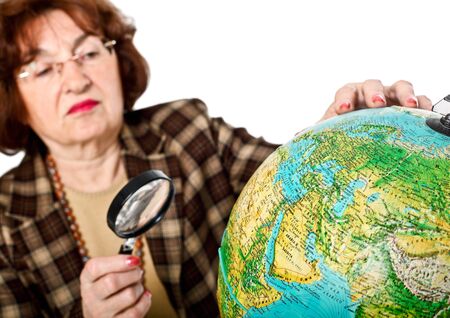 senior woman look globe world map