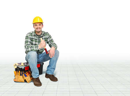 smiling caucasian handyman sit on toolbox
