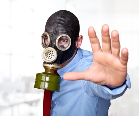 businessman with gas mask in officeの写真素材