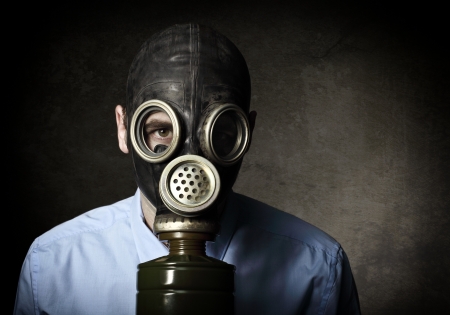 businessman wear gas mask grunge backgroundの写真素材