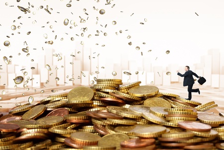 caucasian businessman run on euro coin pileの写真素材