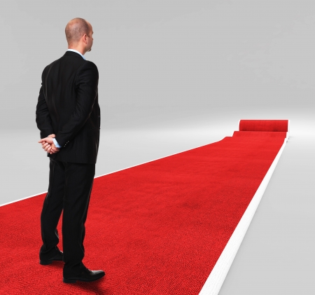 3d image of classic red carpet with standing manの写真素材