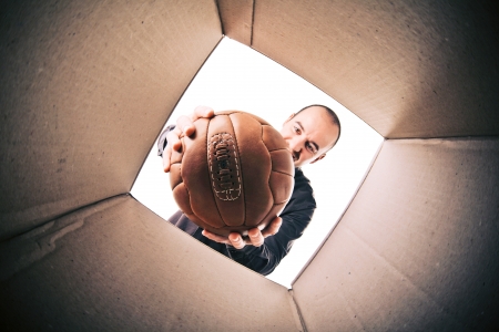 caucasian man got a new vintage soccer ballの写真素材