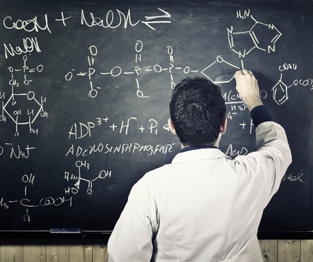 teacher writing on classic blackboardの写真素材