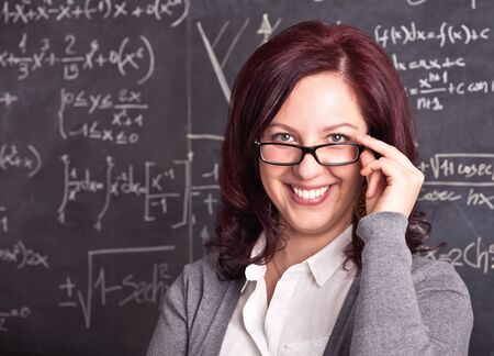 portrait of woman teacher and blackboard backgroundの写真素材