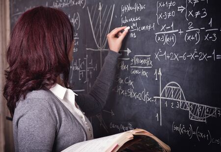 portrait of woman teacher and blackboard backgroundの写真素材