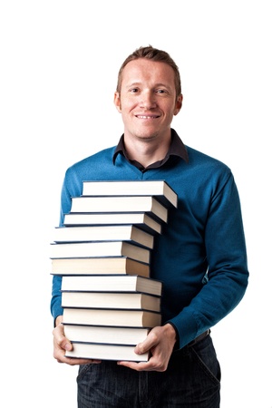 smiling man with a pile of booksの写真素材
