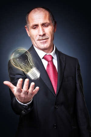 portrait of senior and electric bulb