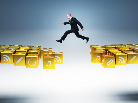 businessman man jump over icons bridgeの写真素材