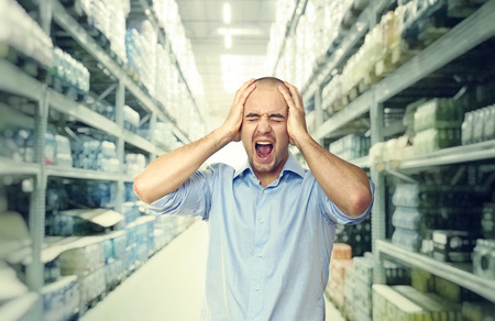 stressed man and shop warehouse backgroundの写真素材