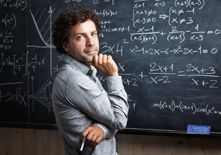 portrait of caucasian teacher and blackboard background