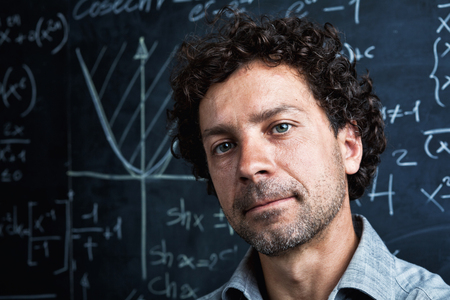 portrait of caucasian teacher and blackboard background