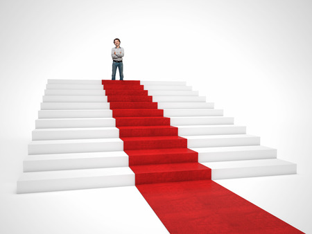 smiling man on top of red carpet stairの写真素材