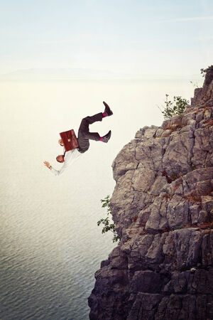 businessman fall from cliff backgroundの写真素材