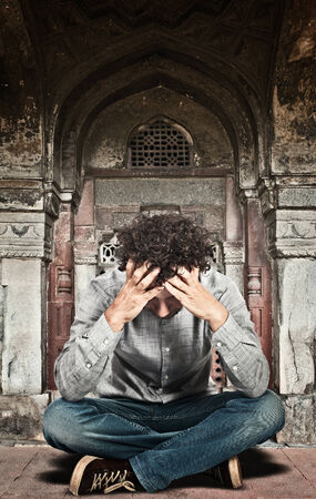 stressed man and ruin construction backgroundの写真素材