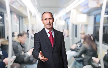 senior businessman portrait on trainの写真素材