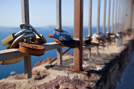 Oia,Santorini, GREECE - June 14, 2015:padlocks with love message left on the fence of the castle of Oiaのeditorial素材