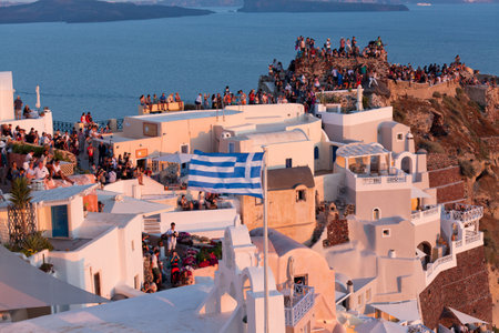 Oia,Santorini, GREECE - June 14, 2015:A CROWD OF TOURISTS AWAITS THE FAMOUS SANTORINI SUNSETのeditorial素材