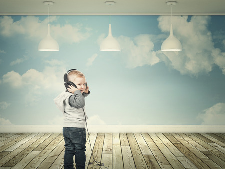 smiling kid with headphone and 3d interiorの写真素材
