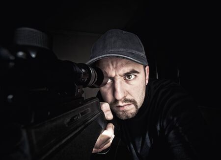 portrait of caucasian sniper with rifleの写真素材