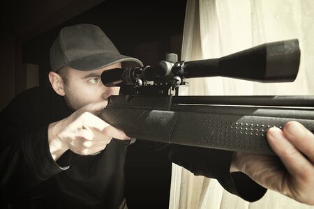 portrait of caucasian sniper with rifleの写真素材
