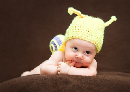 portrait of newborn with snail woolen hatの写真素材