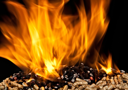 burning wood pellet with flameの写真素材