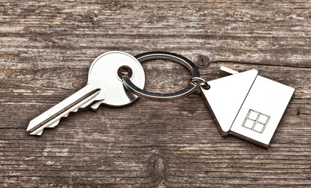 house key ring and old wood background