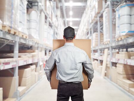 caucasian delivery man in warehouse