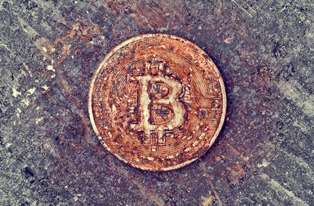 old and rusty bitcoin obsolescence of virtual payment conceptの写真素材