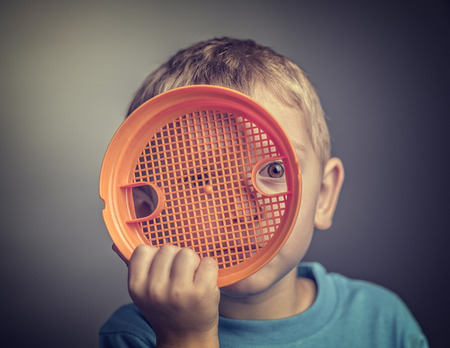 Preventing Child Abuse concept portrait of kid hide himself with toyの写真素材