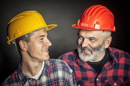 concept of family industry father and son with protection helmetの写真素材
