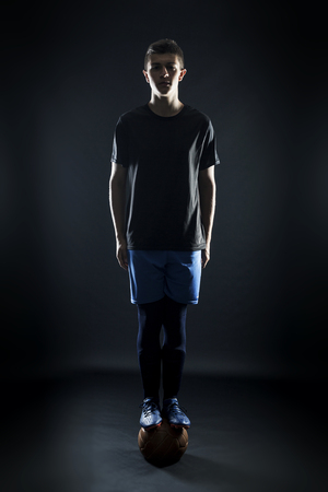 portrait of football player balanced on ballの写真素材