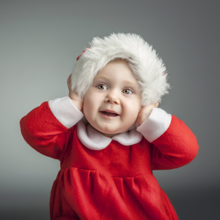 portrait of cute female caucasian child with santa claus clothesの写真素材
