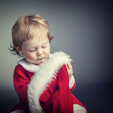 portrait of cute female caucasian child with santa claus clothesの写真素材