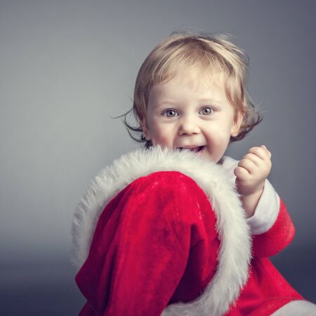 portrait of cute female caucasian child with santa claus clothesの写真素材