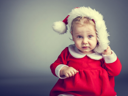 portrait of cute female caucasian child with santa claus clothesの写真素材