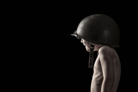 portrait of child soldier on black backgroundの写真素材